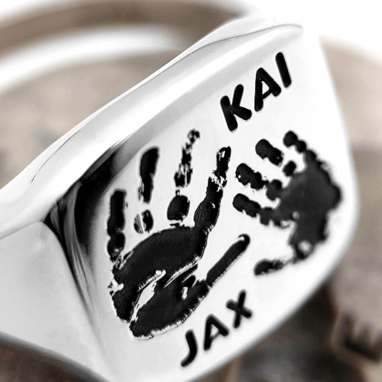 Silver signet ring back with engraved Kai and Jax handprints