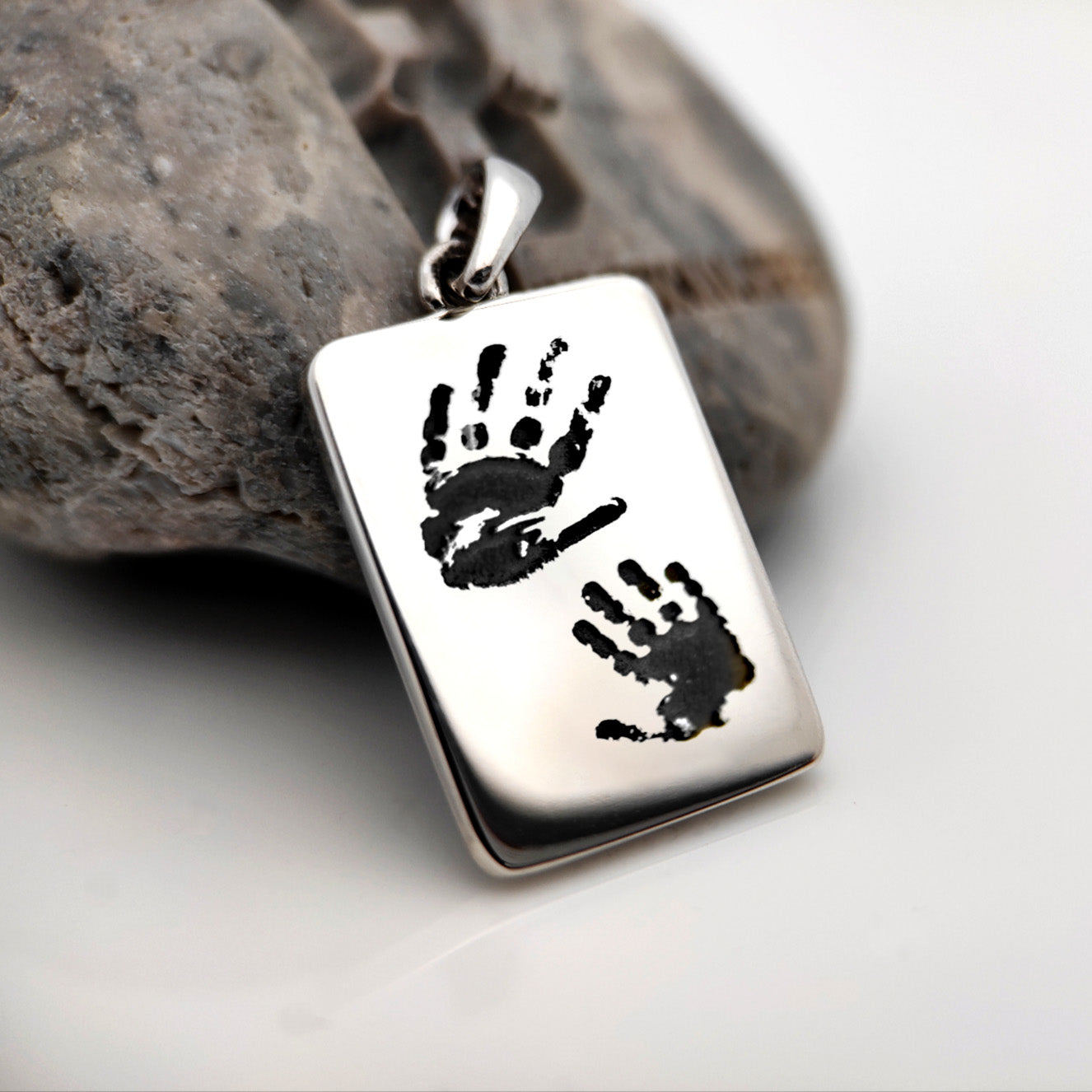 Silver rectangular pendant with two black handprints, 925 sterling silver