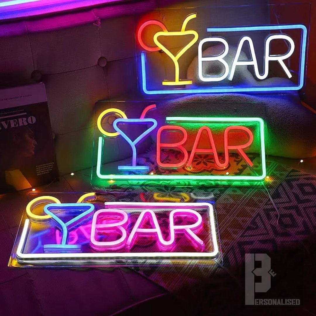Three colorful neon bar signs with glowing martini glass icons