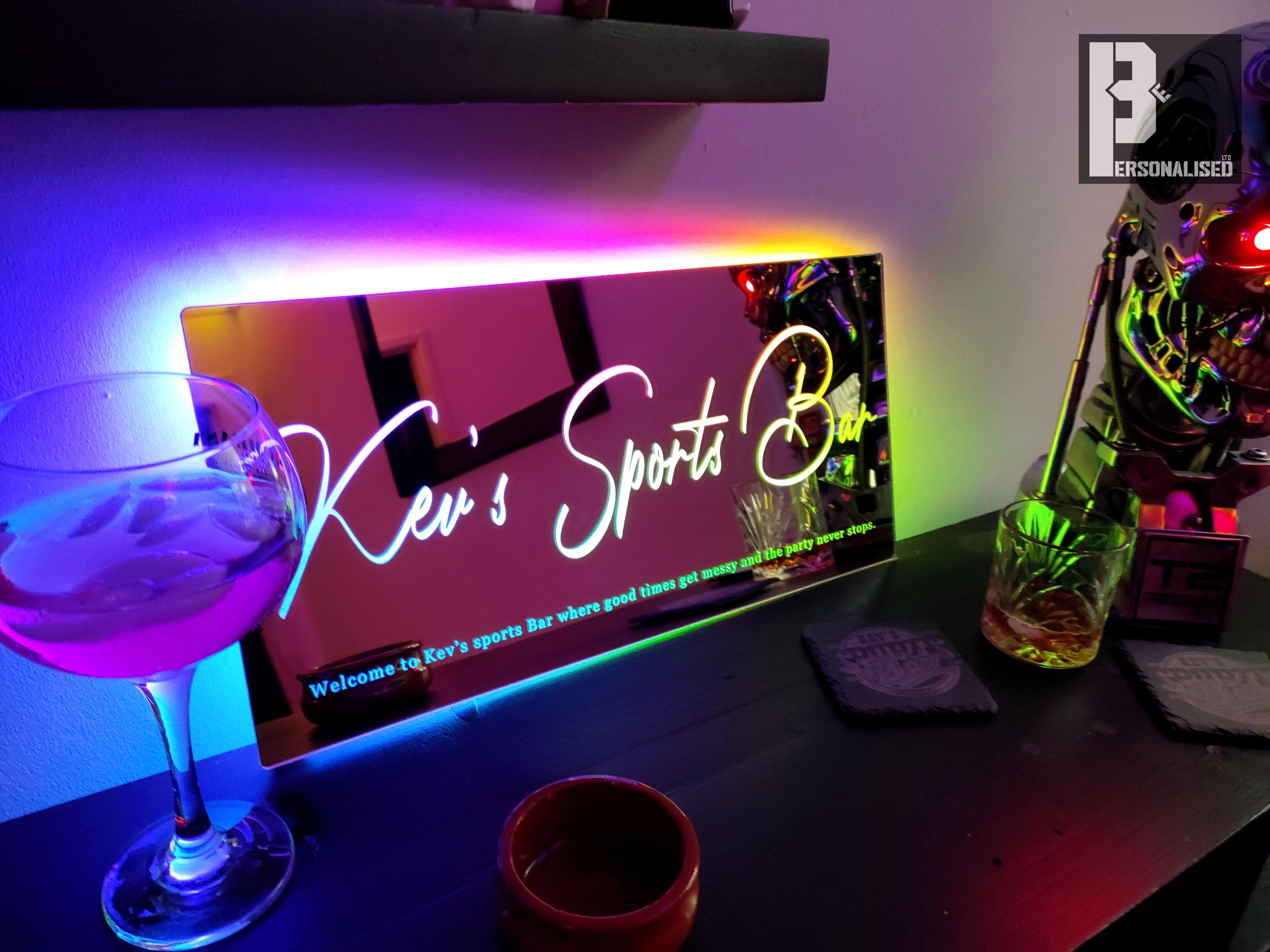 Sleek mirrored LED neon sign: Kevs sports bar in white cursive rainbow glow