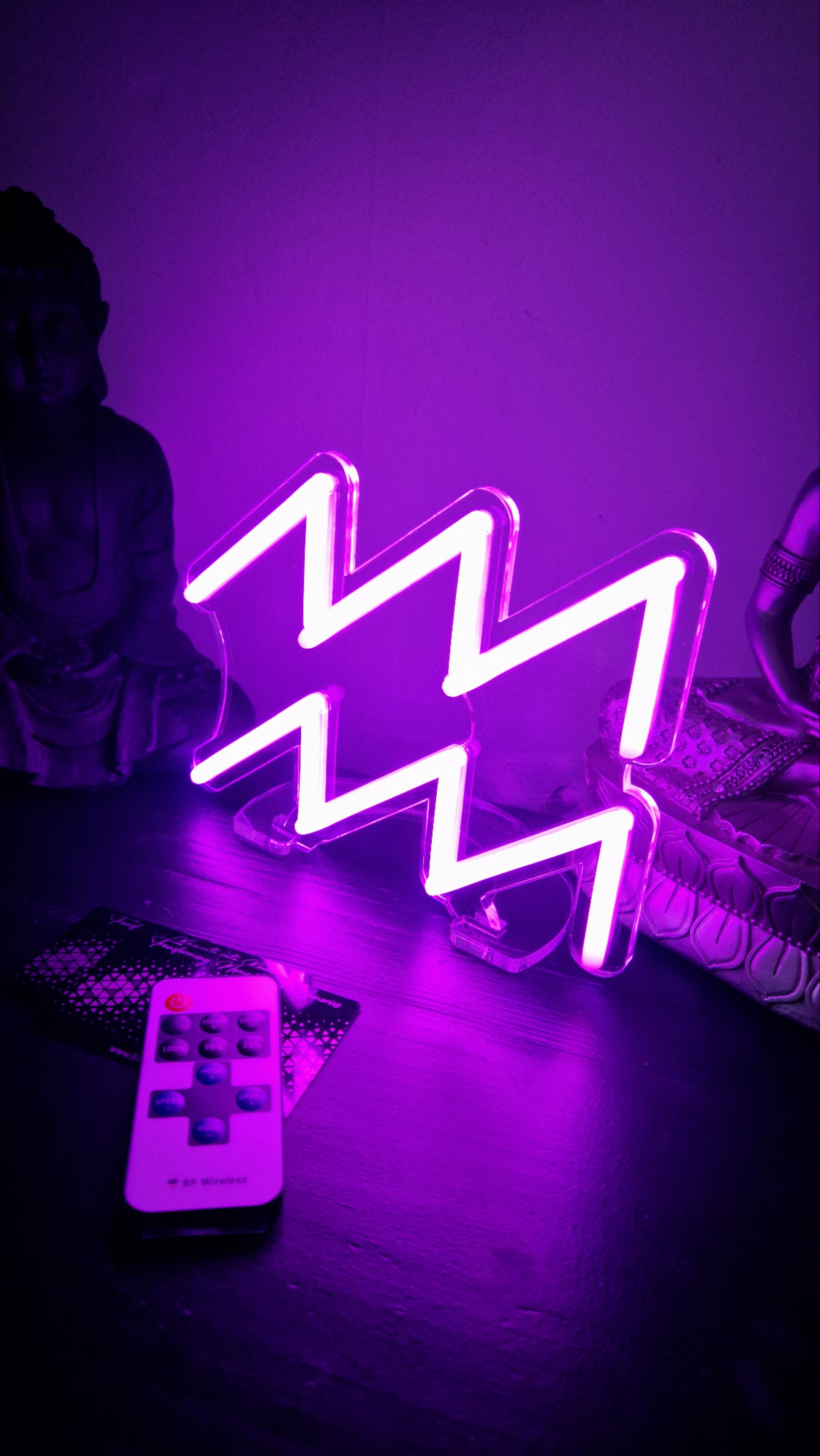 Purple Aquarius zodiac neon sign with waves symbol โ